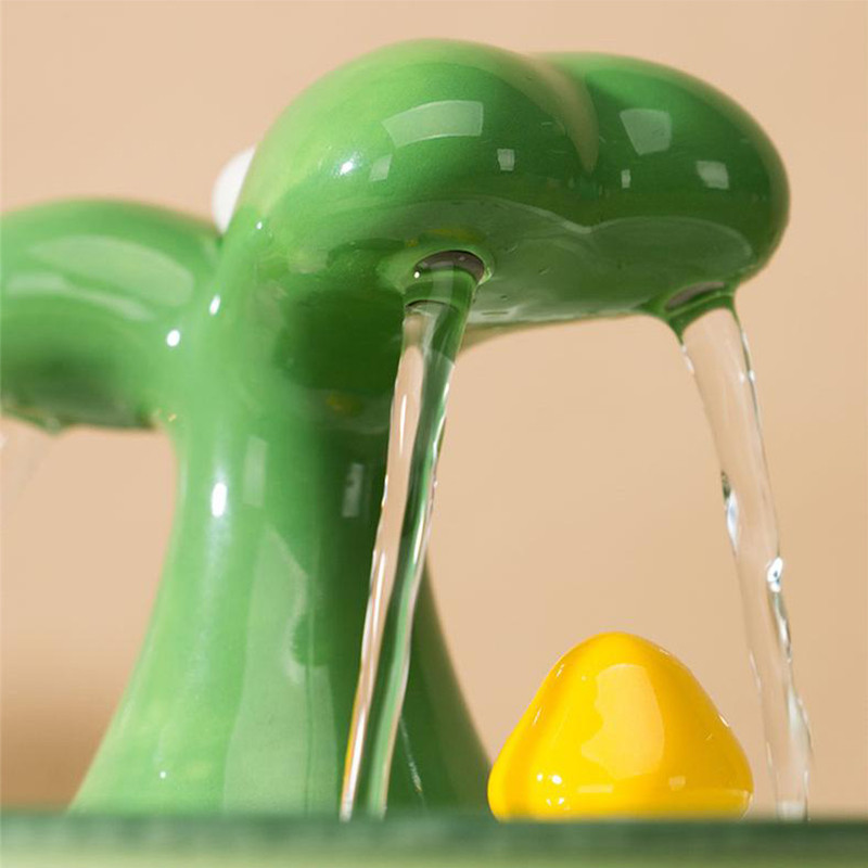 a green faucet with a yellow object under it