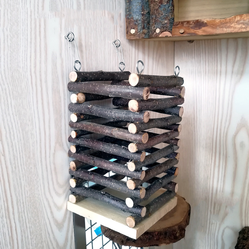 A stack of logs, shaped like an eprolo Applewood Hay Feeder - Chew Friendly for Hamster, Gerbils, Birds, and Rats, hanging on a wall.