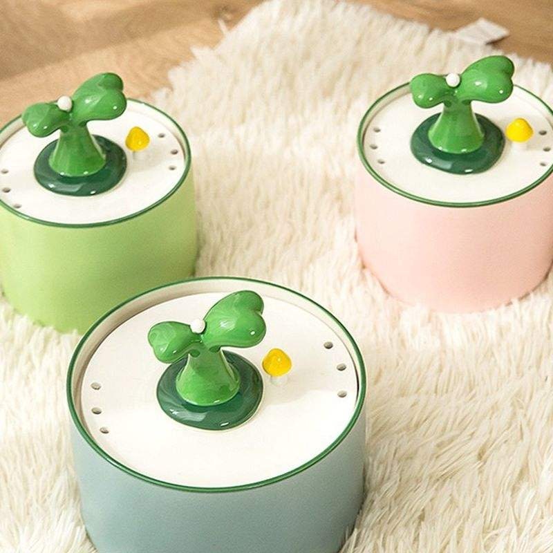 a group of three green and pink toy items on a white rug